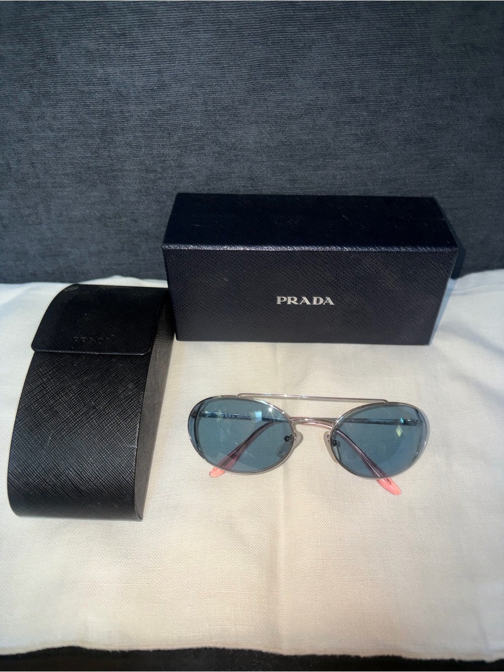 Prada Silver Frame Sunglasses with Teal Blue Lenses